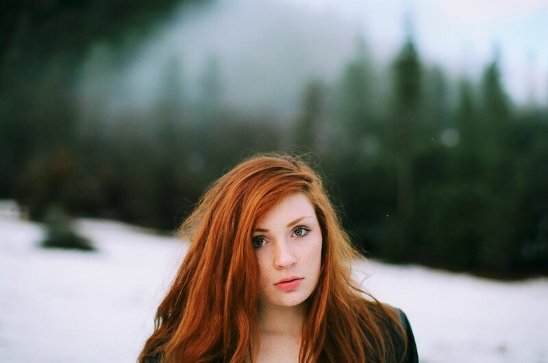 Red-haired woman in snowy forest