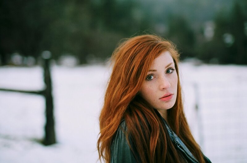 Red-haired woman in snowy landscape