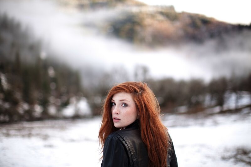 Red-haired woman in snowy landscape