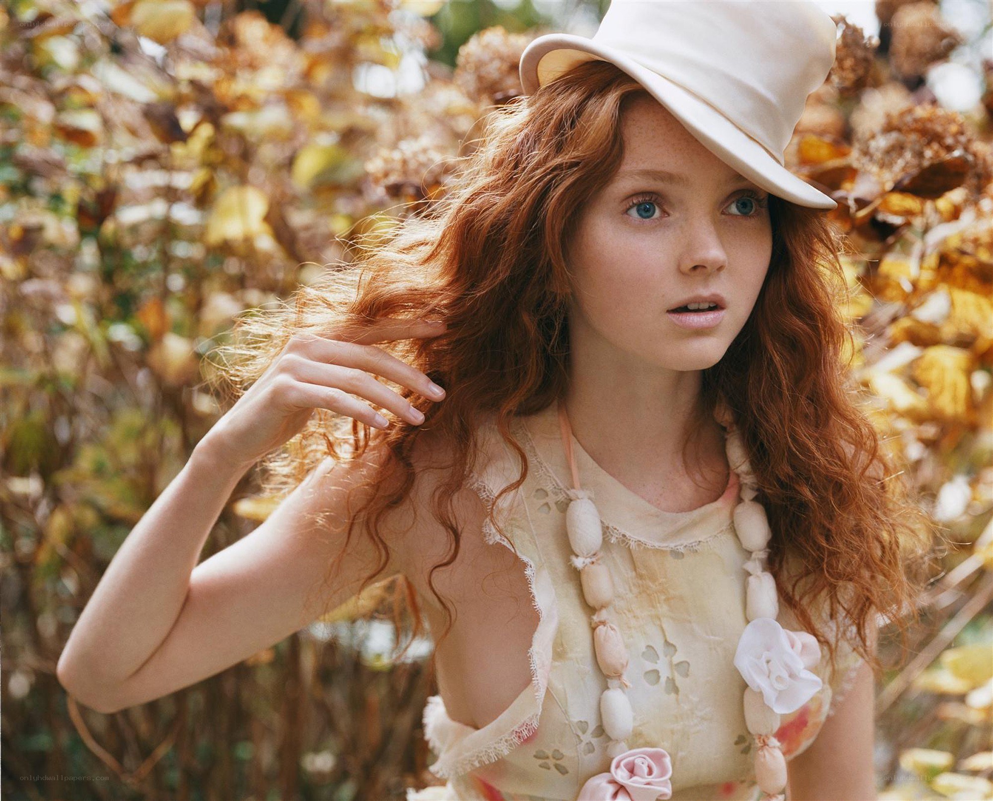 Red-haired woman in white hat