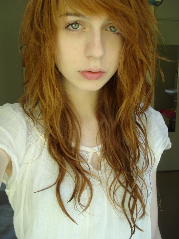 red-haired woman in white shirt