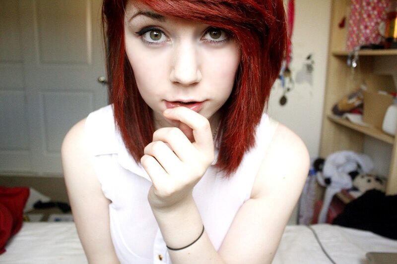 red-haired woman in white shirt