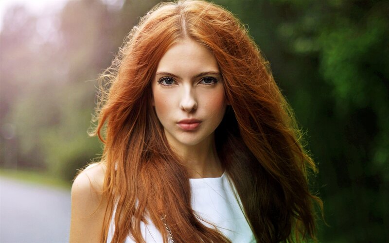 red-haired woman in white top