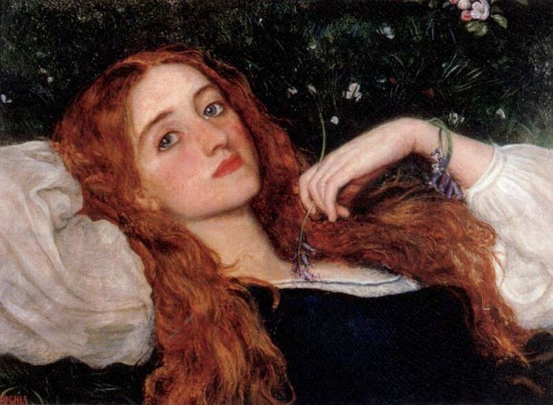 Red-haired woman lying in grass