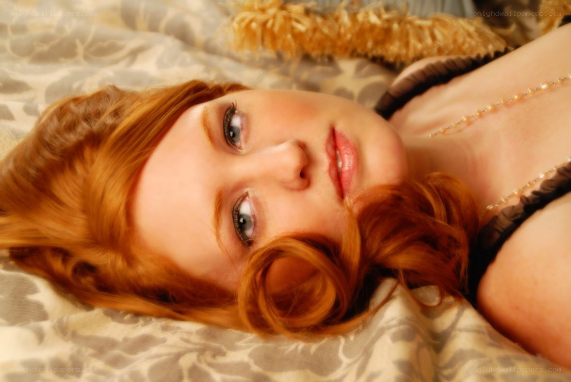 red-haired woman lying on bed