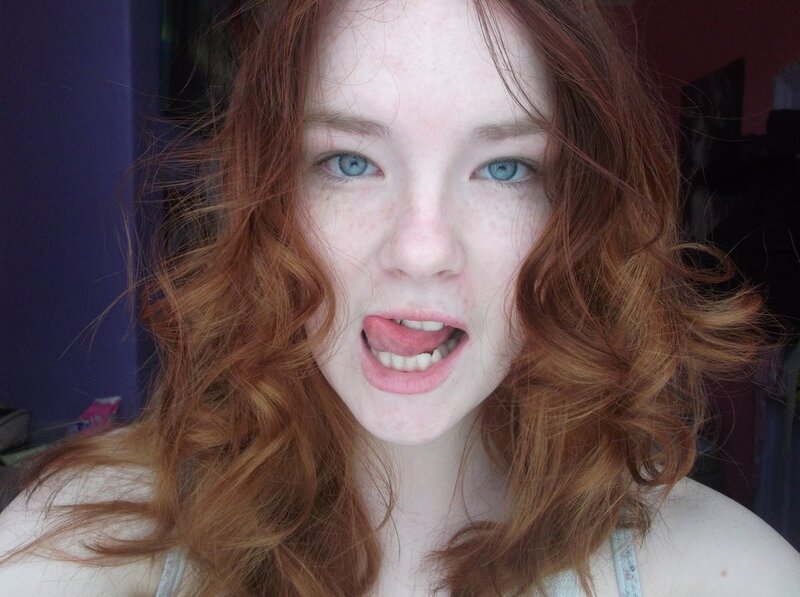 red-haired woman making a face