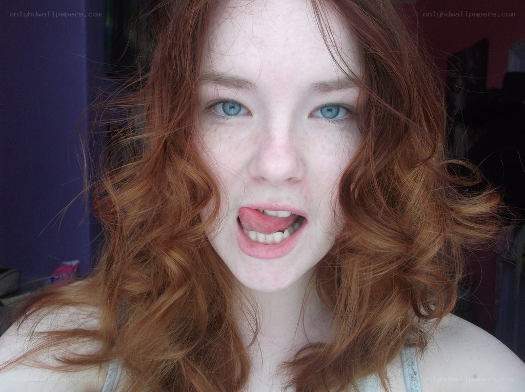 red-haired woman making a face