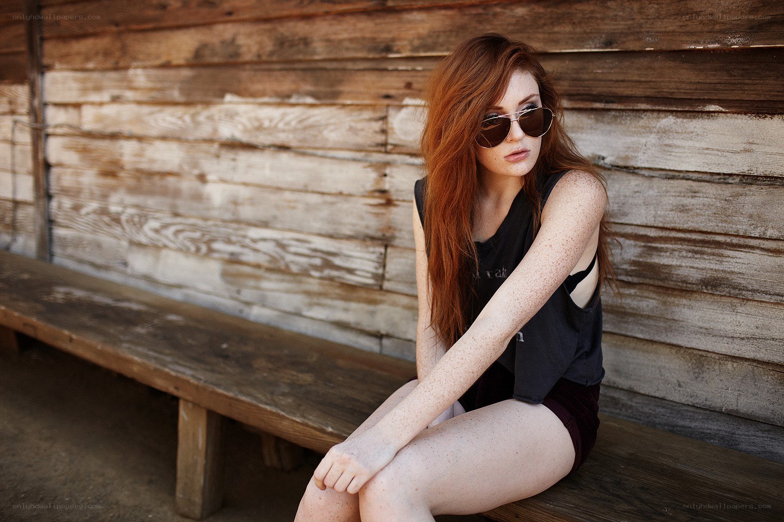 Red-haired woman on a bench