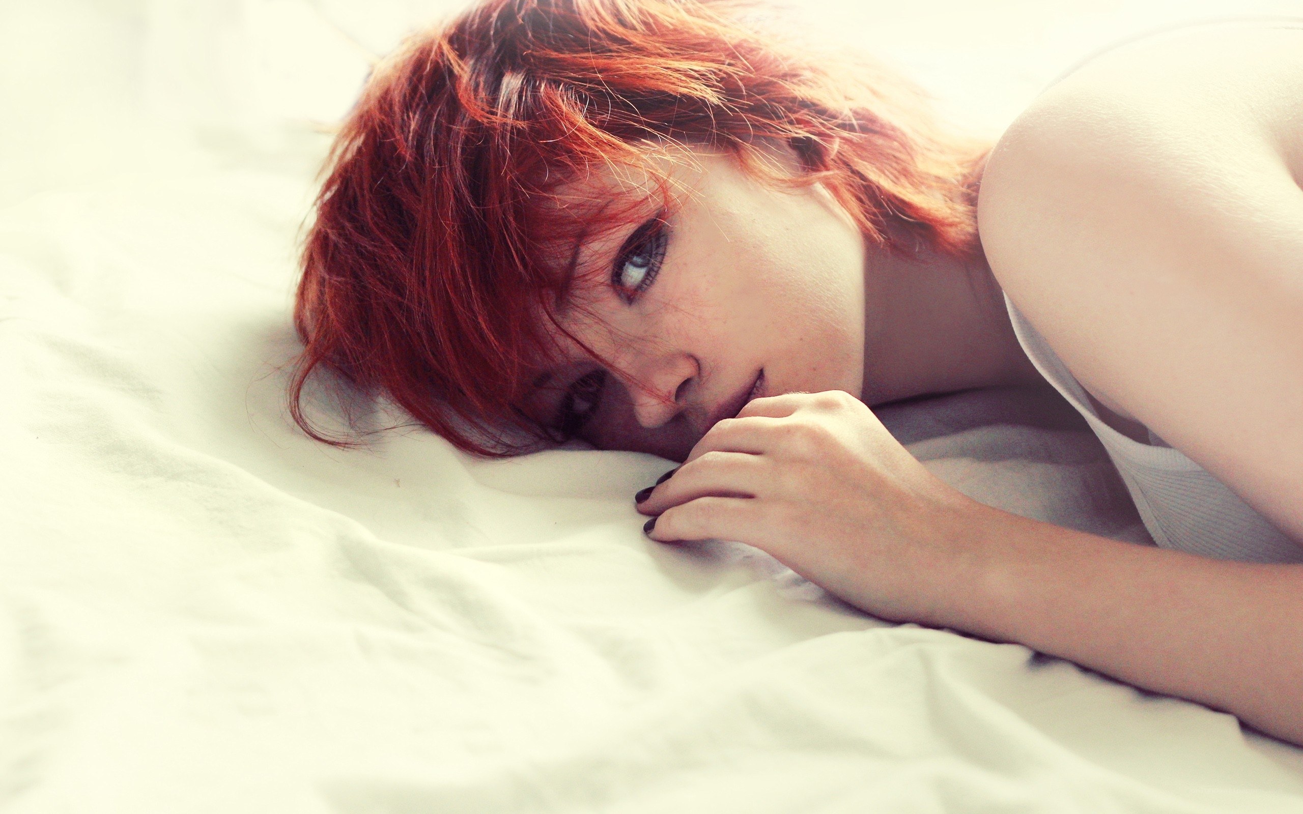 Red-haired woman on bed