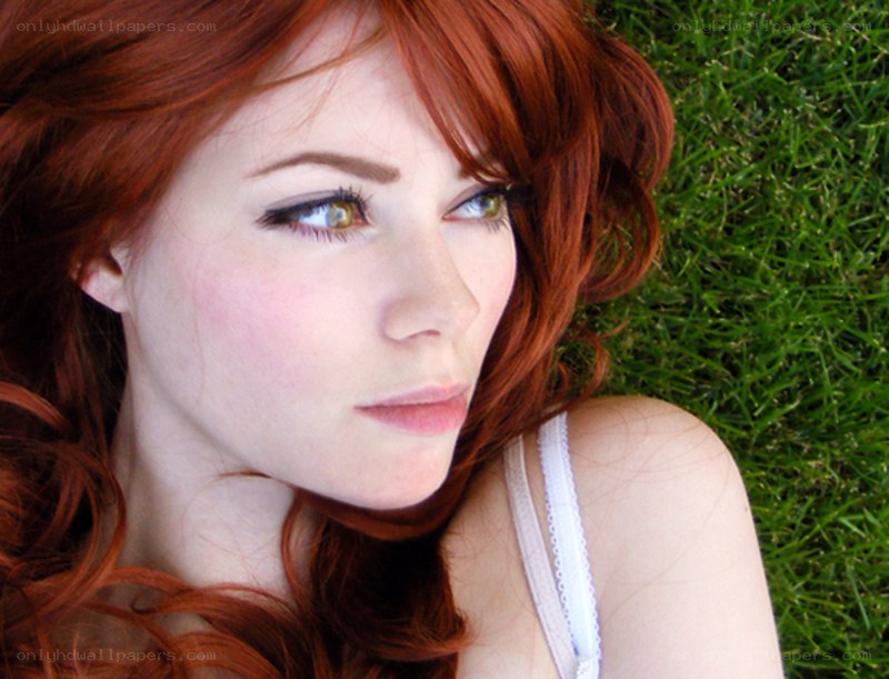 Red-haired woman on grass