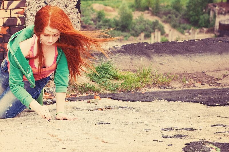Red-haired woman on pavement
