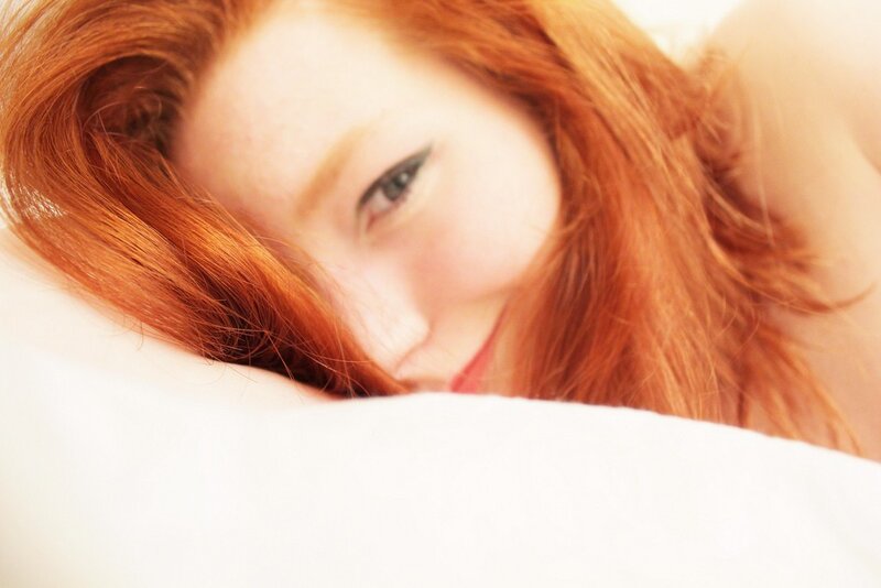 red-haired woman on pillow
