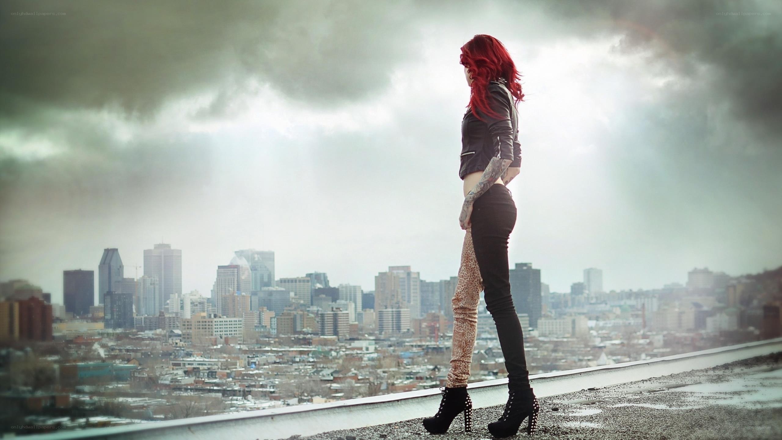 Red-haired woman on rooftop