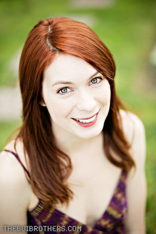 red-haired woman smiling outdoors