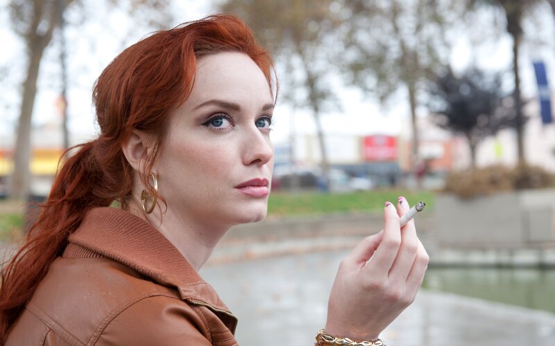 Red-haired Woman Smoking — Red