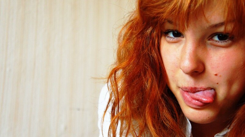 red-haired woman sticking out tongue