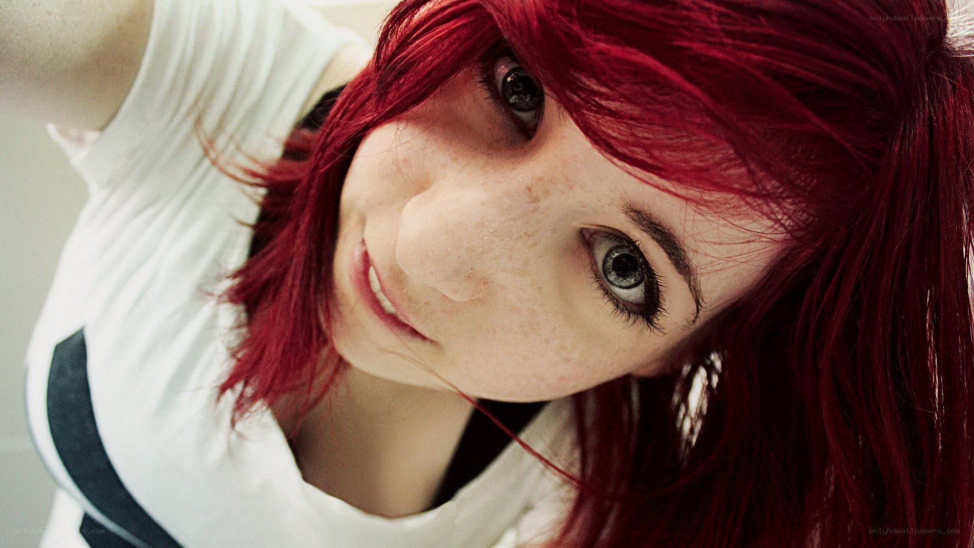 red-haired woman taking selfie