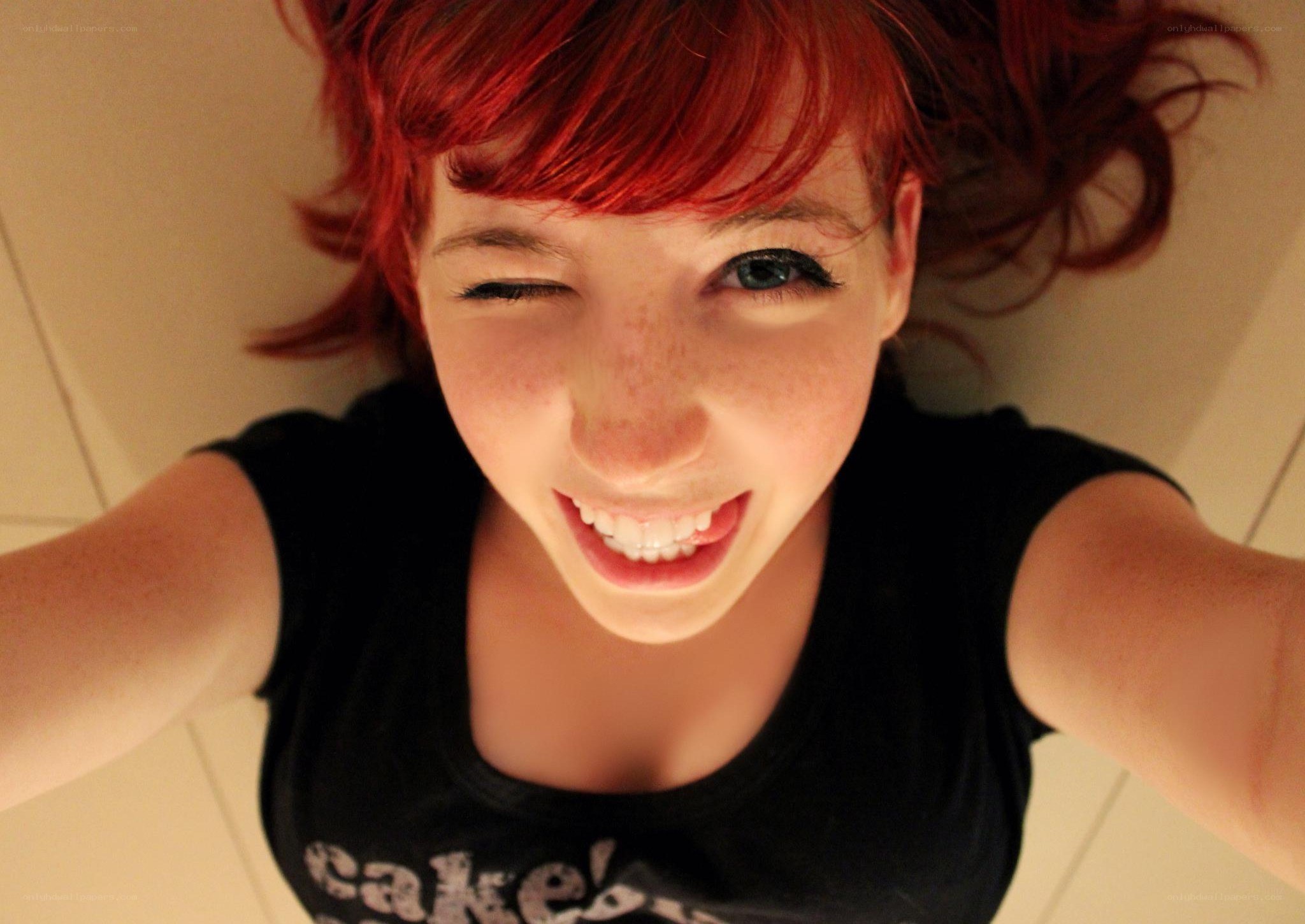red-haired woman winking at camera