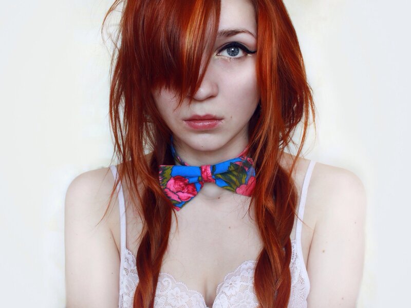 Red-haired woman with bow tie