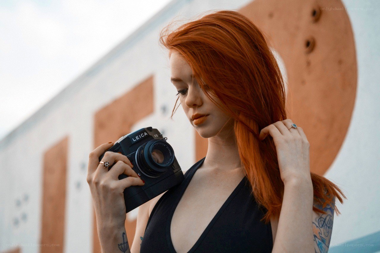 Red-haired woman with camera