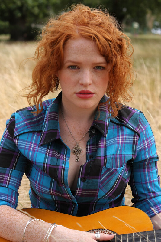 Red-haired woman with guitar