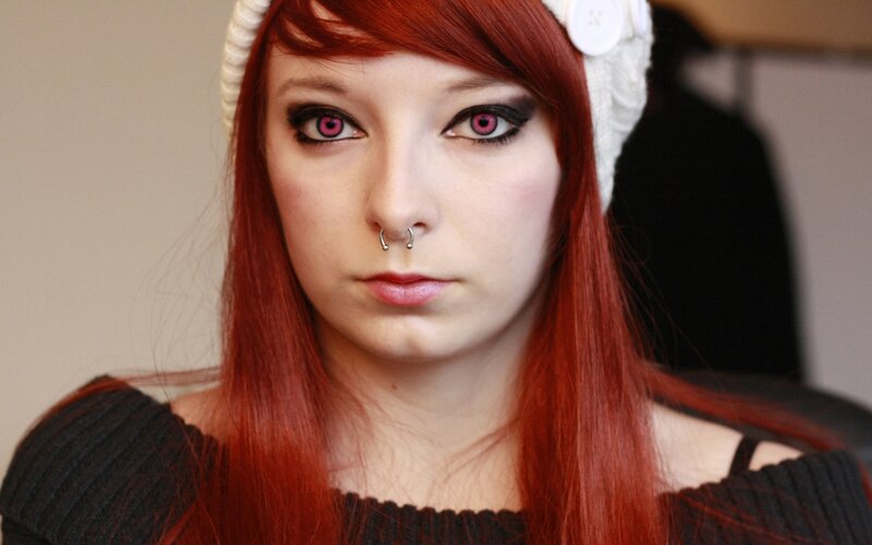 red-haired woman with pink eyes