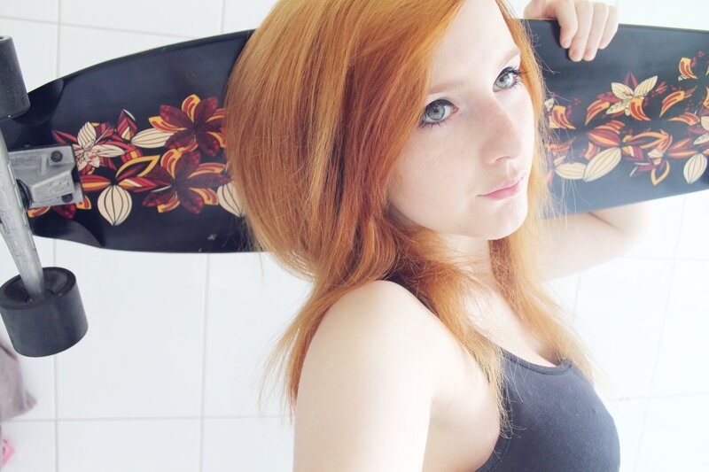 Red-haired woman with skateboard