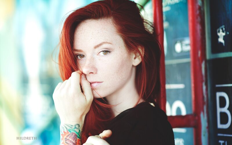 red-haired woman with tattoo
