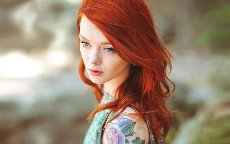 red-haired woman with tattoo