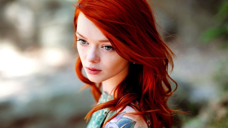 red-haired woman with tattoo