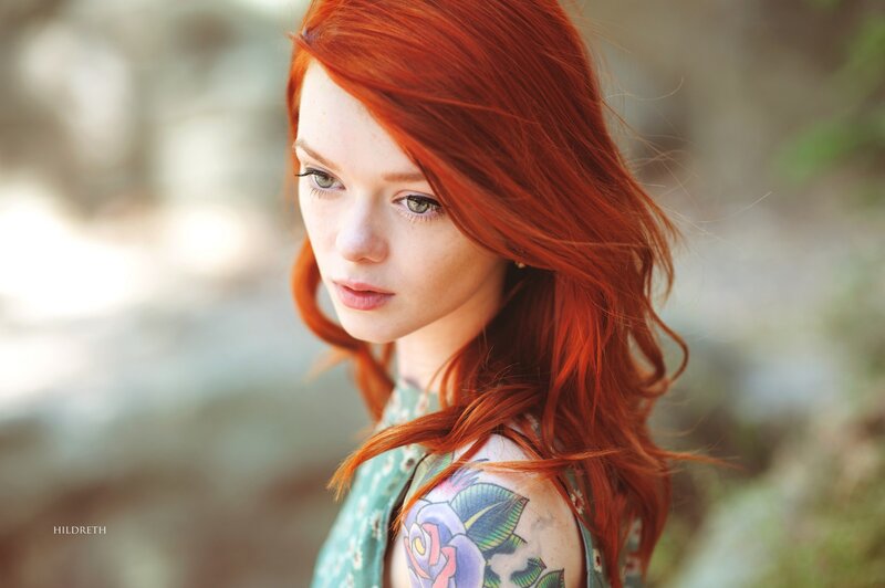 red-haired woman with tattoo