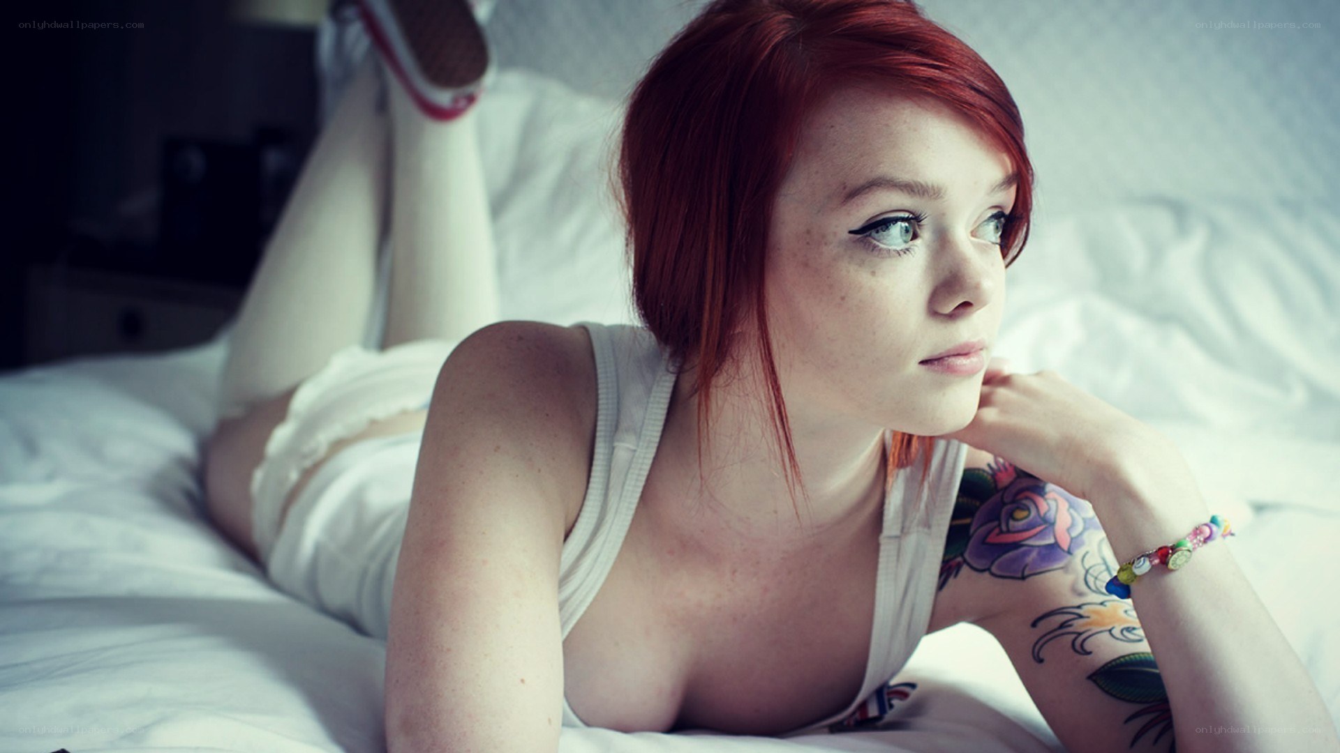 Red-haired woman with tattoos