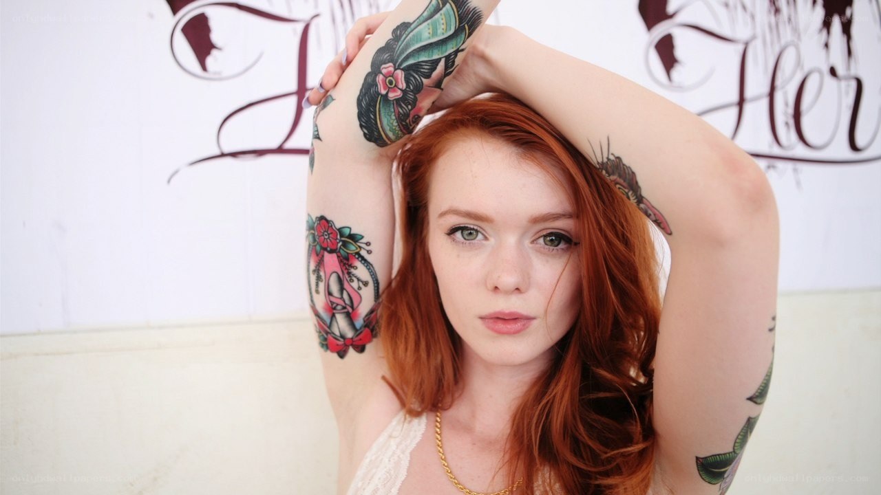 Red-haired woman with tattoos