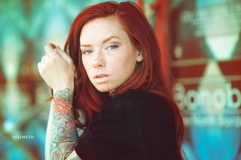 Red-haired woman with tattoos