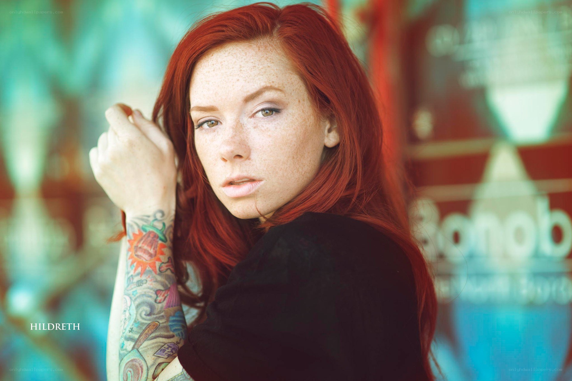 Red-haired woman with tattoos