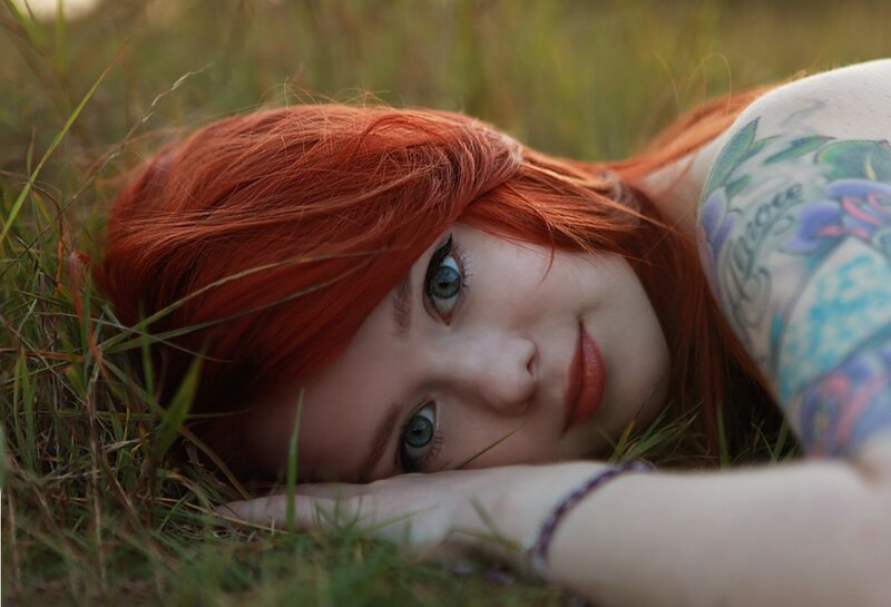 red-haired woman with tattoos