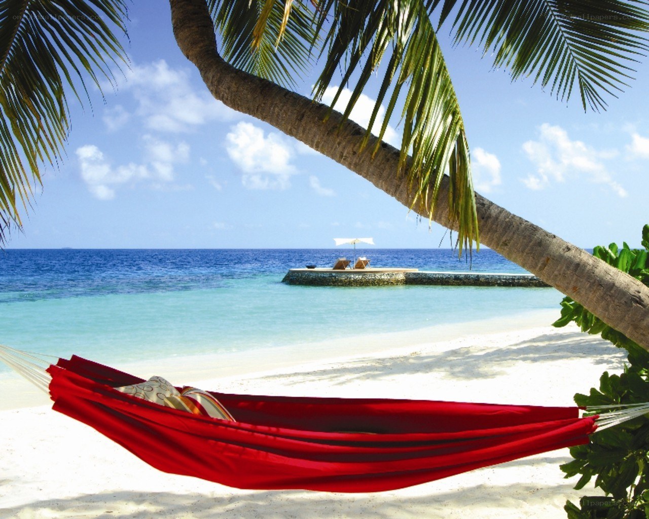 Red hammock on tropical beach