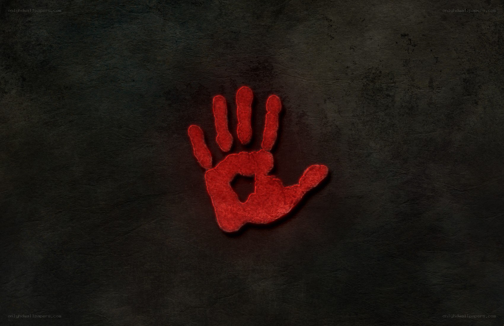 red handprint on dark wall