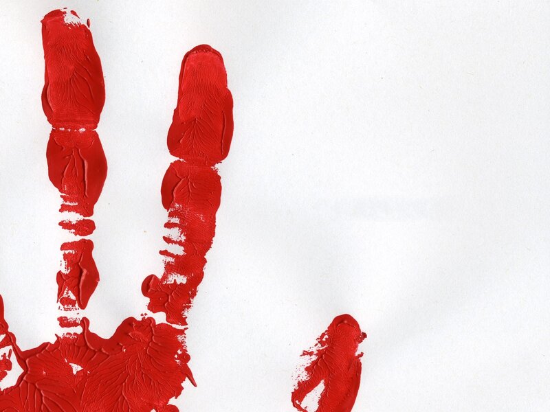Red handprint on white paper