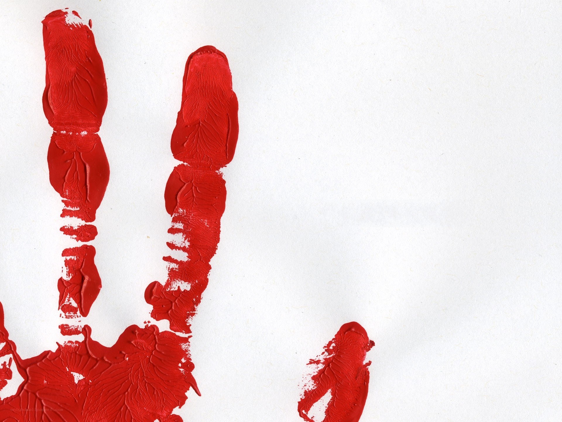 Red handprint on white paper