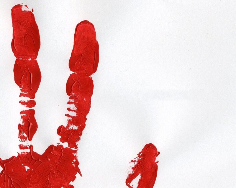Red handprint on white paper