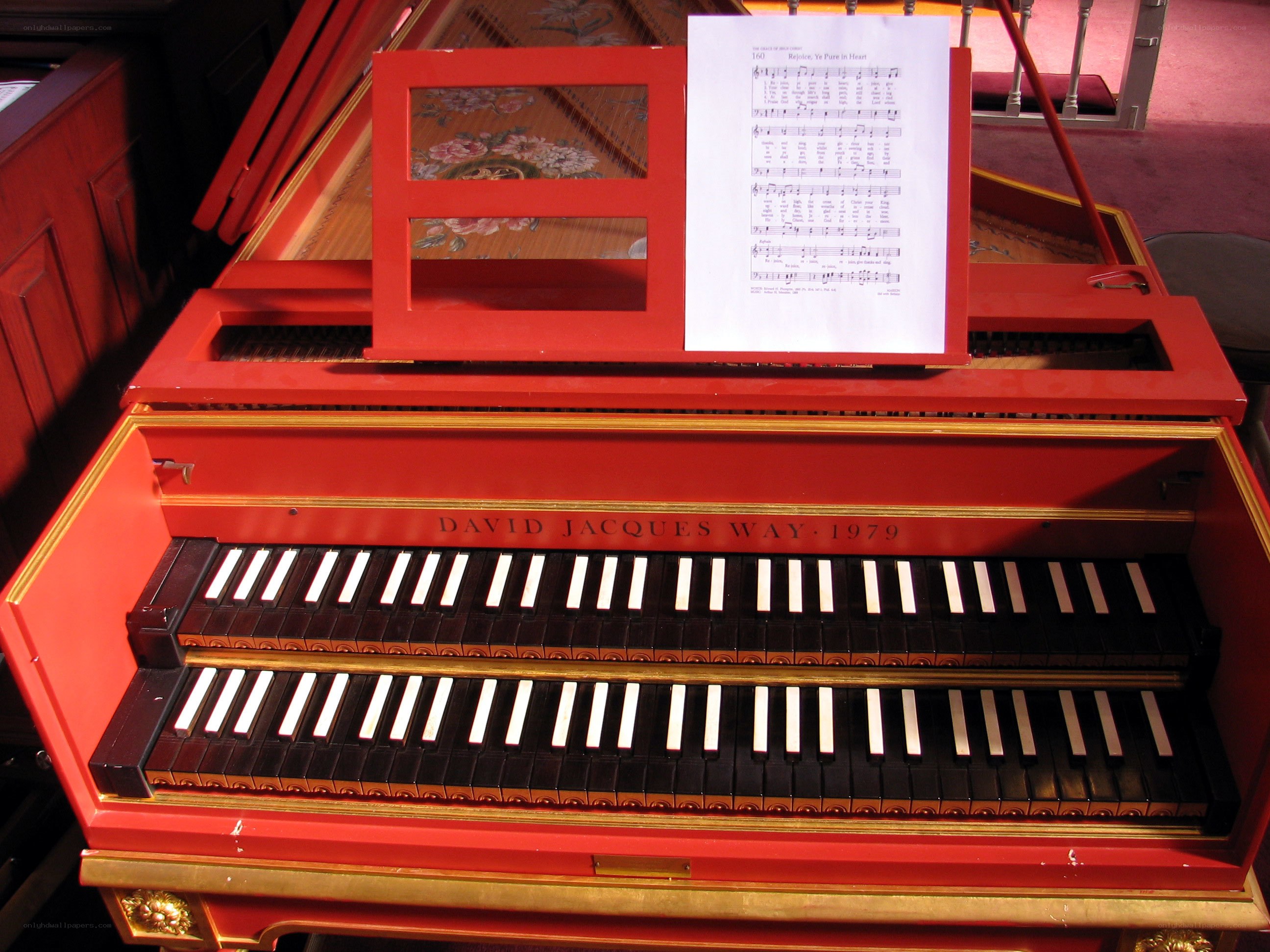 Red harpsichord with sheet music