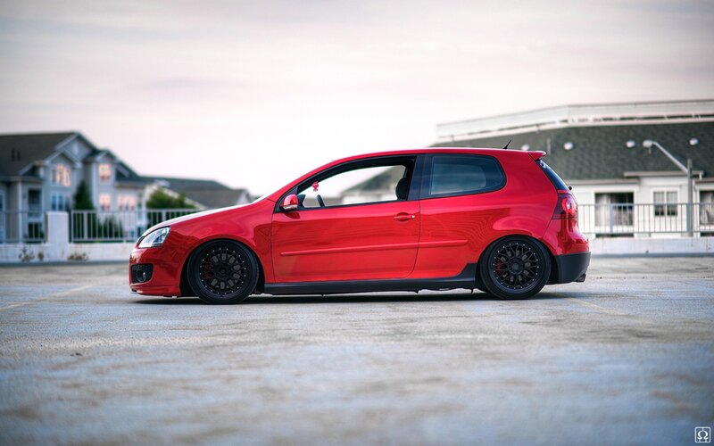 Red hatchback car in parking lot