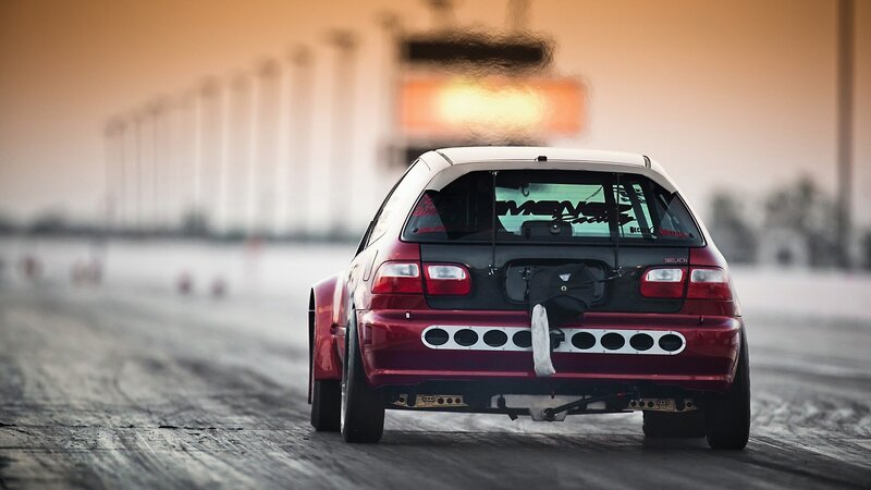 red hatchback on a racetrack