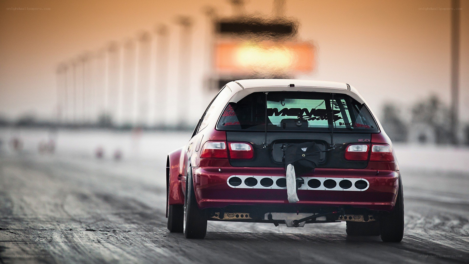 red hatchback on a racetrack