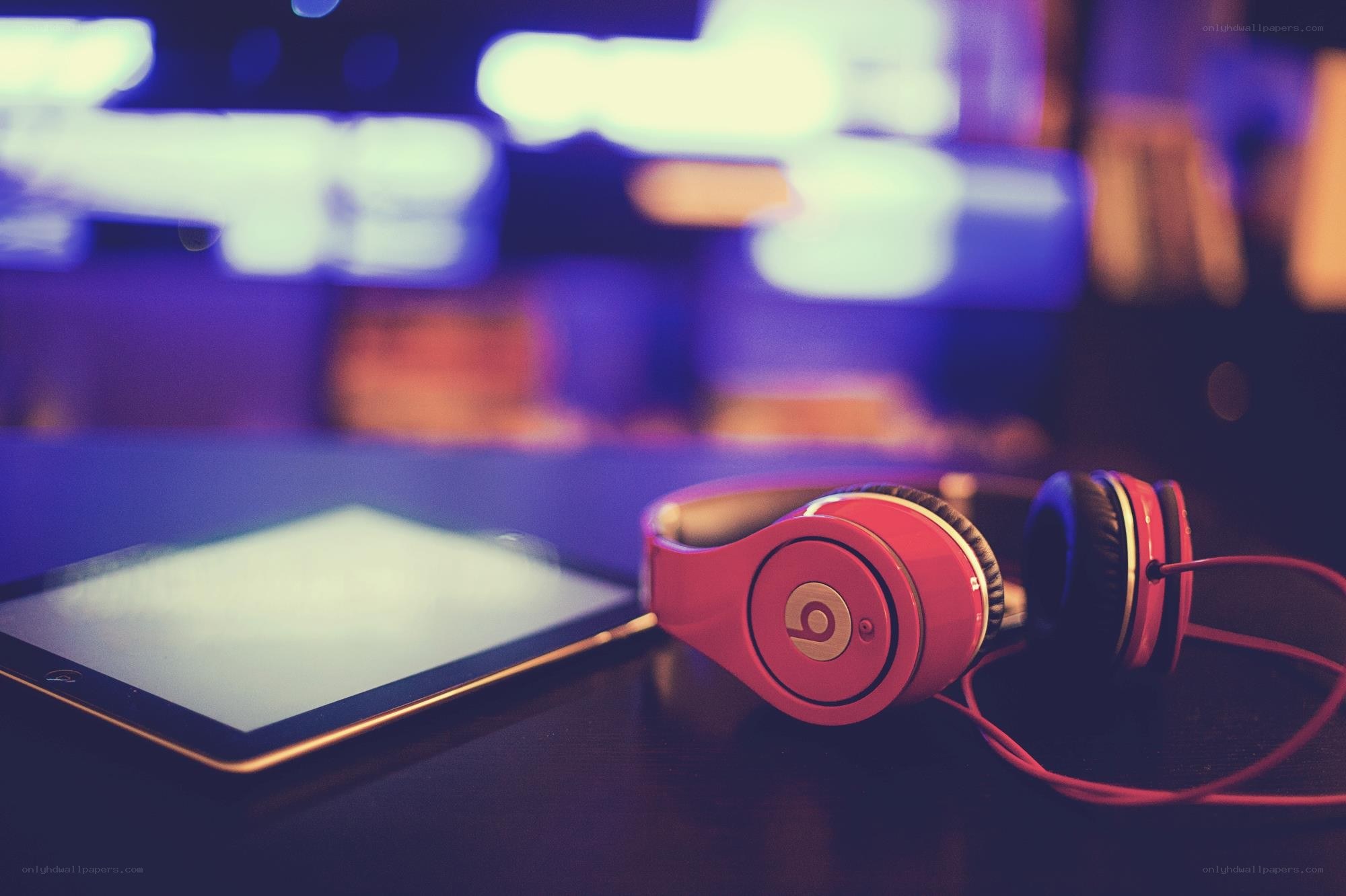 Red headphones and tablet on table