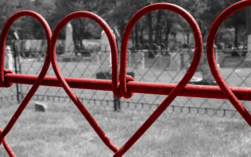 Red heart fence in cemetery