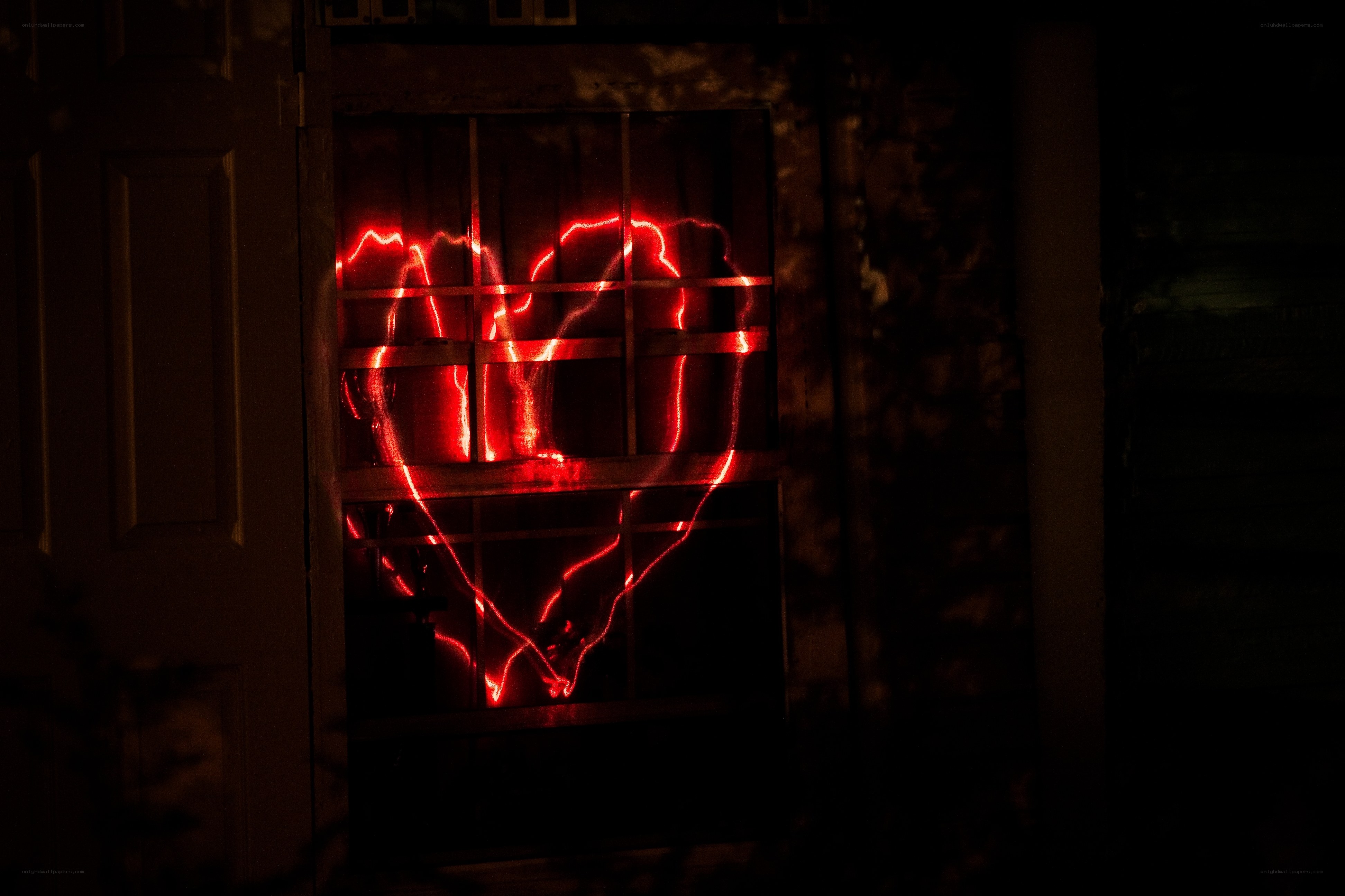 Red heart light in window