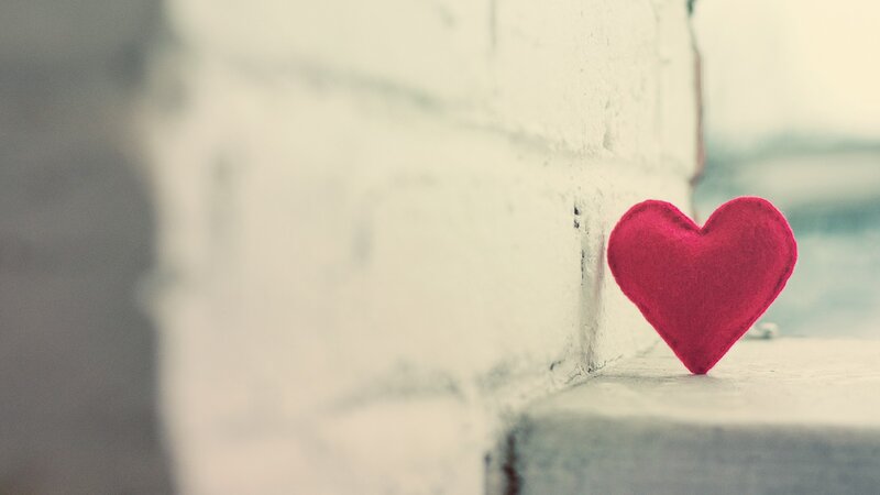 Red heart on white wall