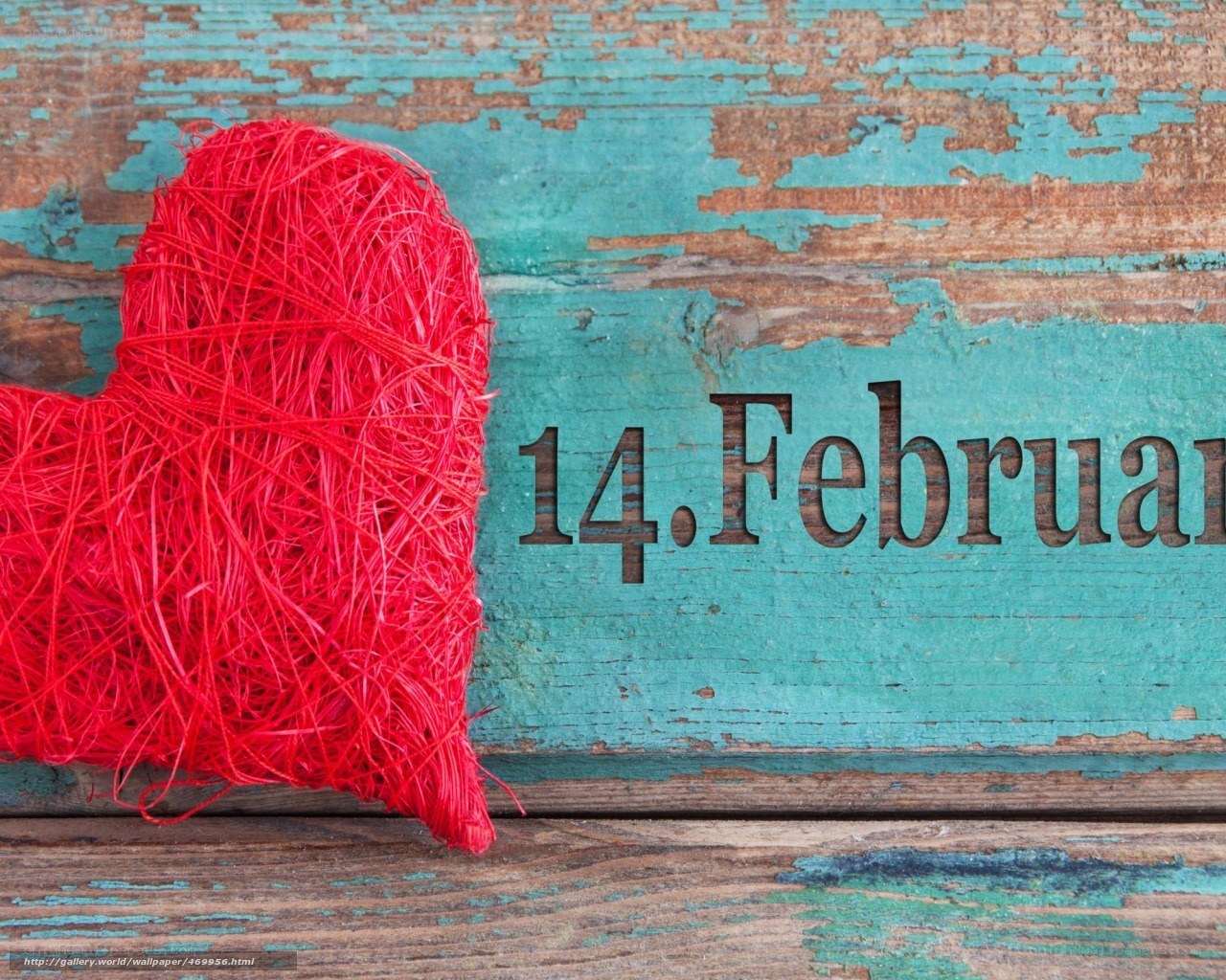 Red heart on wooden background